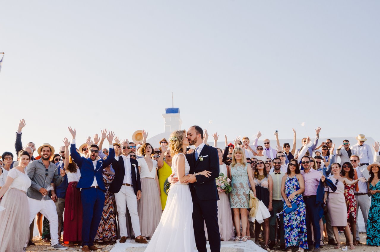 Adis and Panos surrounded by family and friends at their wedding on Koufonisia